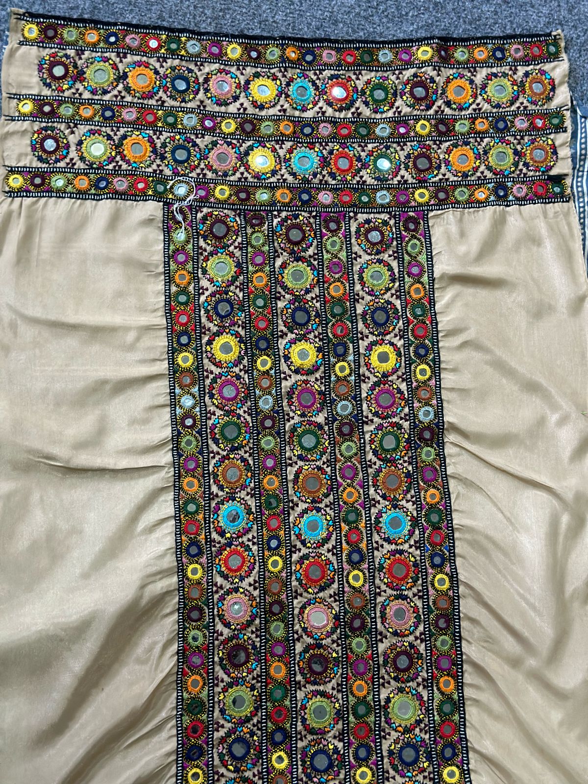 Handmade Balochi embroidery on beige fabric with mirror work and multicolor thread on front and sleeves