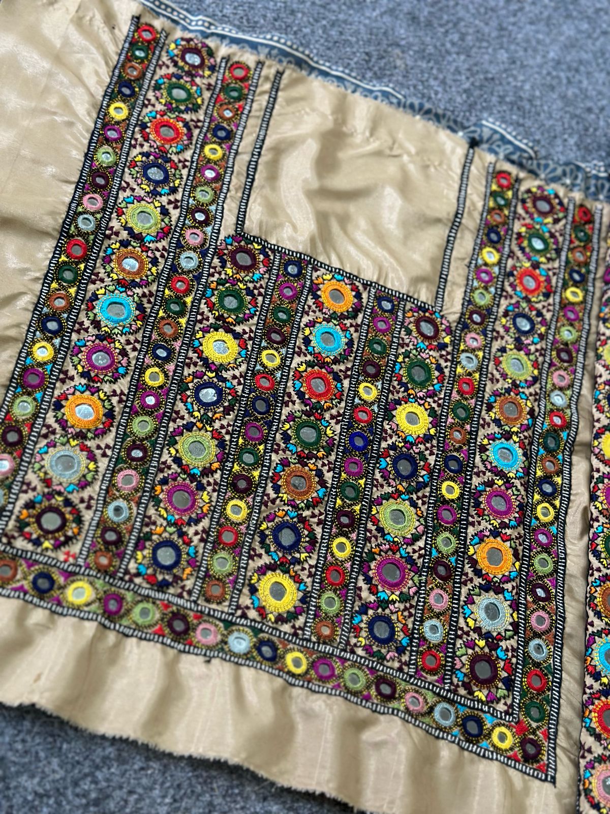 Handmade Balochi embroidery on beige fabric with mirror work and multicolor thread on front and sleeves